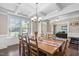 Dining room with a large table, many chairs, coffered ceiling, and natural light at 521 Wildwood Farm Way, Holly Springs, NC 27540
