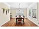 Bright dining room featuring hardwood floors and a stylish chandelier at 521 Wildwood Farm Way, Holly Springs, NC 27540
