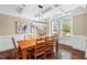 Bright dining area boasts coffered ceilings, hardwood floors and large windows overlooking the backyard at 521 Wildwood Farm Way, Holly Springs, NC 27540