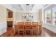 Dining room featuring coffered ceiling, hardwood floors, and abundant natural light for elegant meals at 521 Wildwood Farm Way, Holly Springs, NC 27540