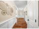 Inviting foyer features wainscoting and hardwood floors leading into an open and airy layout at 521 Wildwood Farm Way, Holly Springs, NC 27540