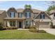 Charming two-story home with a manicured lawn, inviting entrance, and an attached two-car garage at 521 Wildwood Farm Way, Holly Springs, NC 27540