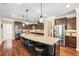 Spacious kitchen island with granite countertops, seating, and stainless steel appliances for modern living and entertaining at 521 Wildwood Farm Way, Holly Springs, NC 27540