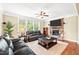 Inviting living room with a cozy fireplace and comfortable seating arrangement, perfect for relaxation at 521 Wildwood Farm Way, Holly Springs, NC 27540