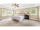Spacious main bedroom with a ceiling fan and lots of natural light at 521 Wildwood Farm Way, Holly Springs, NC 27540
