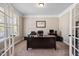 Home office with a large desk, chair, and French doors at 521 Wildwood Farm Way, Holly Springs, NC 27540