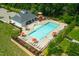 Aerial view showcasing the sparkling community pool with ample seating and lounging areas at 521 Wildwood Farm Way, Holly Springs, NC 27540