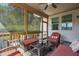 Relaxing screened porch with comfortable seating and an outdoor ceiling fan at 521 Wildwood Farm Way, Holly Springs, NC 27540