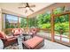 Outdoor screened porch with cozy furniture and nice neighborhood view at 521 Wildwood Farm Way, Holly Springs, NC 27540