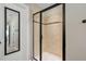 Walk-in shower with glass door and neutral-toned tile at 521 Wildwood Farm Way, Holly Springs, NC 27540