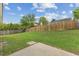 Backyard featuring green grass, a privacy fence and mature trees at 5505 Armada Dr, Raleigh, NC 27610