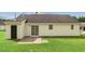 Back of house featuring siding, sliding glass doors, door to garage, and mowed lawn at 5505 Armada Dr, Raleigh, NC 27610