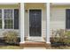 Inviting front entrance featuring a classic door and well-maintained landscaping at 5505 Armada Dr, Raleigh, NC 27610