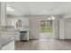 Kitchen featuring stainless steel appliances, white cabinets, and a sliding glass door to backyard at 5505 Armada Dr, Raleigh, NC 27610