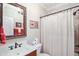 This bathroom features a shower with curtain, a vanity with a beautiful mirror and neutral walls at 572 W Walker Woods Ln, Clayton, NC 27527