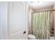 Bathroom features a toilet and walk in shower with curtain at 572 W Walker Woods Ln, Clayton, NC 27527