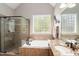 Bright bathroom featuring a walk-in shower, soaking tub, and vanity with granite countertops at 572 W Walker Woods Ln, Clayton, NC 27527