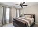 Comfortable bedroom featuring a ceiling fan, neutral paint, and ample natural light from the windows at 572 W Walker Woods Ln, Clayton, NC 27527