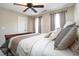 This bedroom has a ceiling fan, neutral paint, and lots of natural light at 572 W Walker Woods Ln, Clayton, NC 27527