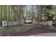 Stone entrance to the Walker Woods community, surrounded by towering trees at 572 W Walker Woods Ln, Clayton, NC 27527