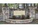 Stone sign for Walker Woods community, framed by lush greenery and shrubbery at 572 W Walker Woods Ln, Clayton, NC 27527