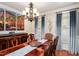 Elegant dining room with a large wooden table, chandelier, and natural light from the window at 572 W Walker Woods Ln, Clayton, NC 27527