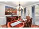 Elegant dining room with a large wooden table, chandelier, and decorative wall art at 572 W Walker Woods Ln, Clayton, NC 27527