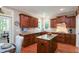 Well-lit kitchen showcasing wooden cabinets, granite counters, and access to an adjacent dining area at 572 W Walker Woods Ln, Clayton, NC 27527