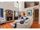 Spacious living room with stone fireplace, large windows, and access to the kitchen and dining area at 572 W Walker Woods Ln, Clayton, NC 27527