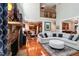 Inviting living room features a stone fireplace, large windows, and an open layout leading to the kitchen at 572 W Walker Woods Ln, Clayton, NC 27527