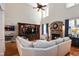 Cozy living room with a stone fireplace, entertainment center, and views of the upstairs balcony at 572 W Walker Woods Ln, Clayton, NC 27527