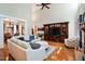 Open-concept living room with high ceilings, hardwood floors, and large built-in entertainment center at 572 W Walker Woods Ln, Clayton, NC 27527
