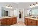 Spacious bathroom with dual vanities, large mirrors, and a doorway leading to an adjacent space at 572 W Walker Woods Ln, Clayton, NC 27527