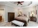 Comfortable main bedroom featuring neutral tones, decorative pillows, and tray ceiling at 572 W Walker Woods Ln, Clayton, NC 27527