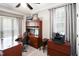 Cozy home office space featuring built-in desk, shelving, and ample natural light at 572 W Walker Woods Ln, Clayton, NC 27527