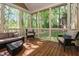 Open and airy screened porch featuring outdoor seating and scenic views of the surrounding landscape at 572 W Walker Woods Ln, Clayton, NC 27527