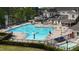 Large community pool with lounge chairs and a waterslide, perfect for relaxation at 572 W Walker Woods Ln, Clayton, NC 27527