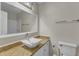 Bathroom with a modern sink, granite countertop, decorative mirror, and toilet at 5900 Shady Grove Cir, Raleigh, NC 27609
