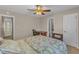 Bedroom with a bed, desk, chair, ceiling fan, and an ensuite bathroom at 5900 Shady Grove Cir, Raleigh, NC 27609