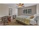 A cozy bedroom featuring a ceiling fan, a comfortable bed and a window with a view at 5900 Shady Grove Cir, Raleigh, NC 27609