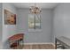 Bright dining area with an elegant chandelier, a window with blinds, and wood-look floors at 5900 Shady Grove Cir, Raleigh, NC 27609
