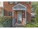 Close up view of the front entryway of the brick townhouse with white door and trim at 5900 Shady Grove Cir, Raleigh, NC 27609
