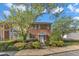 Inviting townhouse with a brick facade, mature trees, and a well-maintained front yard at 5900 Shady Grove Cir, Raleigh, NC 27609
