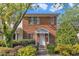 Charming brick townhouse featuring a covered entryway and well-manicured landscaping at 5900 Shady Grove Cir, Raleigh, NC 27609