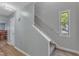 Bright foyer featuring staircase, modern paint colors, and wood-look flooring at 5900 Shady Grove Cir, Raleigh, NC 27609
