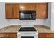Bright kitchen with white appliances, granite countertops, and new subway tile backsplash at 5900 Shady Grove Cir, Raleigh, NC 27609