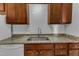 Updated kitchen features granite countertops, white subway tile backsplash, and stainless steel sink at 5900 Shady Grove Cir, Raleigh, NC 27609