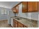 Updated kitchen features granite countertops, white appliances and stainless steel sink at 5900 Shady Grove Cir, Raleigh, NC 27609