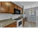 Kitchen features granite countertops, white backsplash and a breakfast nook with natural light at 5900 Shady Grove Cir, Raleigh, NC 27609