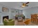 Comfortable living room with fireplace and ceiling fan at 5900 Shady Grove Cir, Raleigh, NC 27609